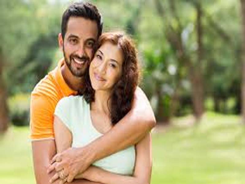 Couple Posing with Beautiful Smile in Garden - December Born Couples