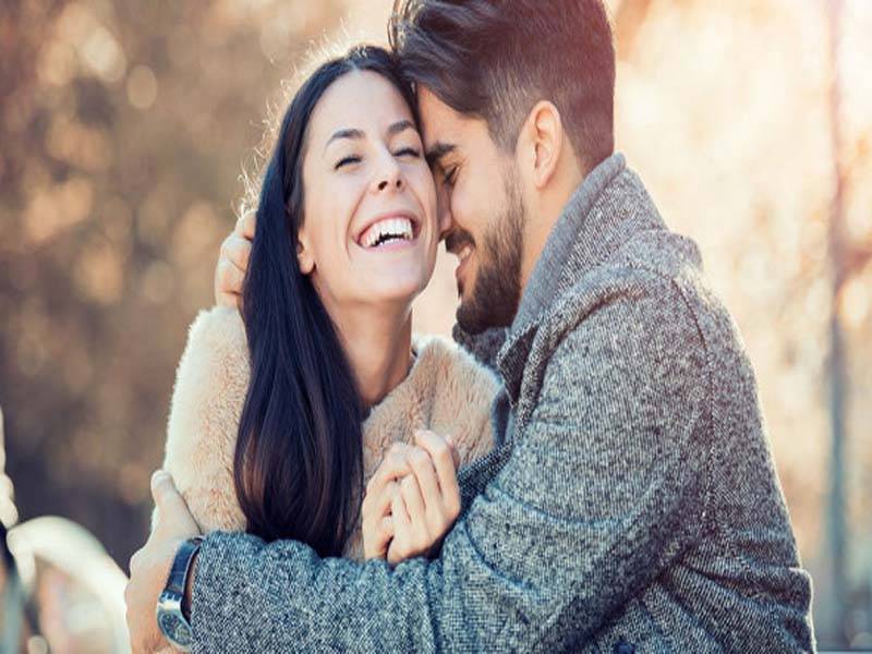 Couple Romantically Laughing and Posing together - December Born Couples