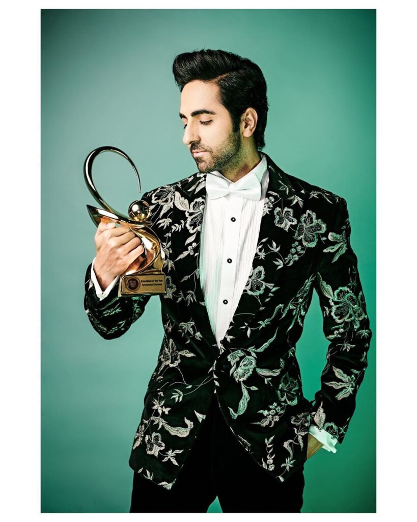 Aayushman Khurana hairstyle - posing in the black jacket, gazing his trophy