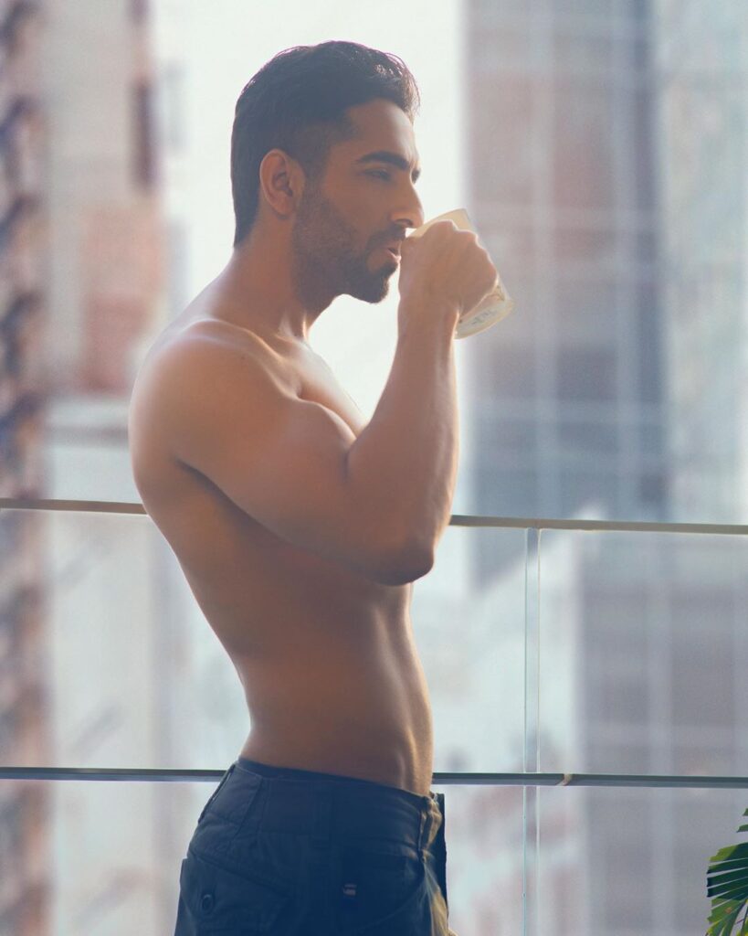 Aayushman Khurana hairstyle - posing in the black trouser, naked torso and posing with having cup in his hand