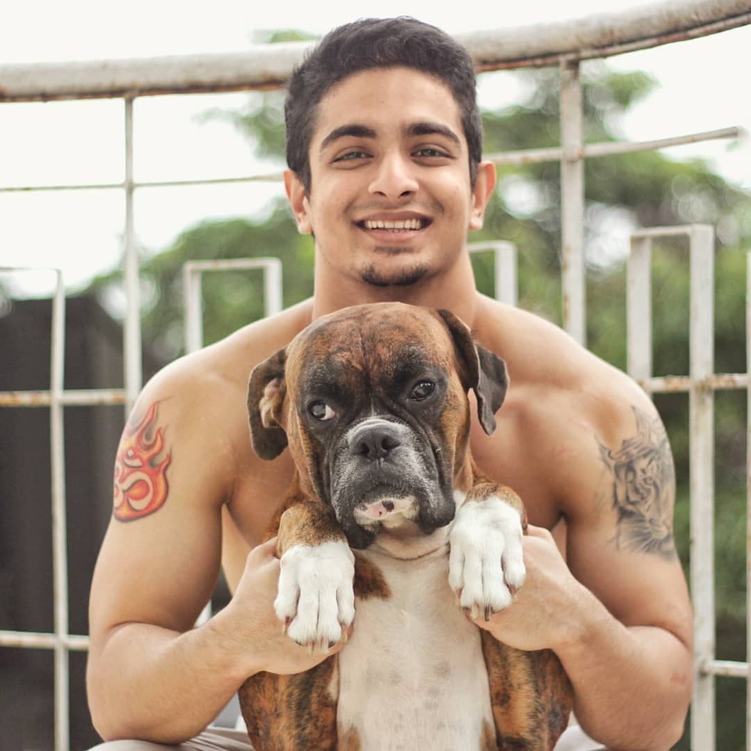 Ranveer Allahbadia top model India - posing with his dog carrying him within hand