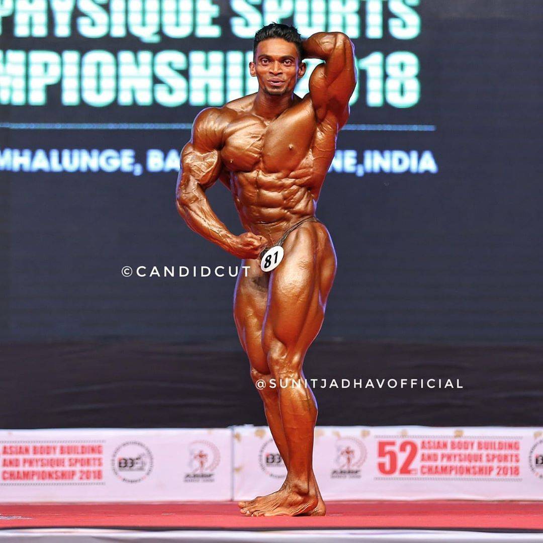 Sunit Jadhav top model India - posing on stage during bodybuilding championship