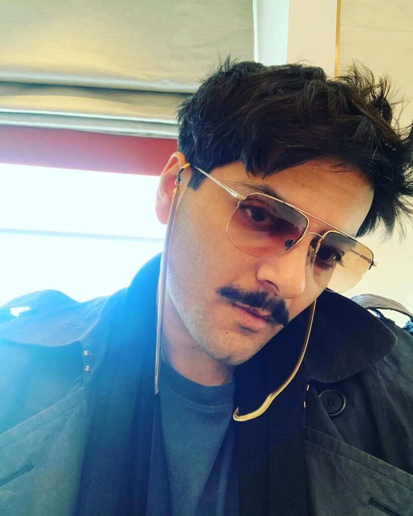 Ali Faizal hairstyle - posing for camera - wearing shades, have mustache - taking selfie with black jacket