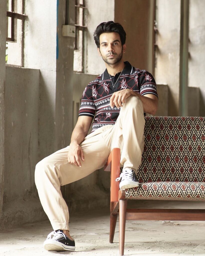 Rajkumar Rao hairstyle - sitting on sofa posing with a straight face