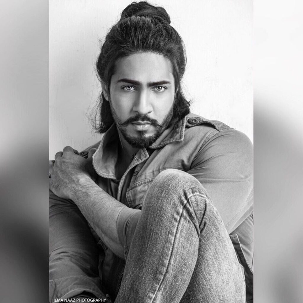 Thakur Anoop Singh Hairstyle - posing for a camera sitting in this black n white photo