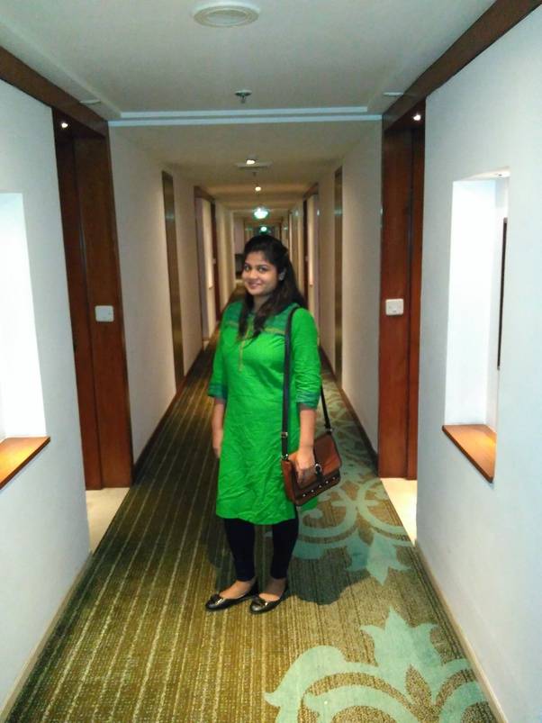 before photo weight loss transformation garima verma - posing in green suit in hotel's lobby