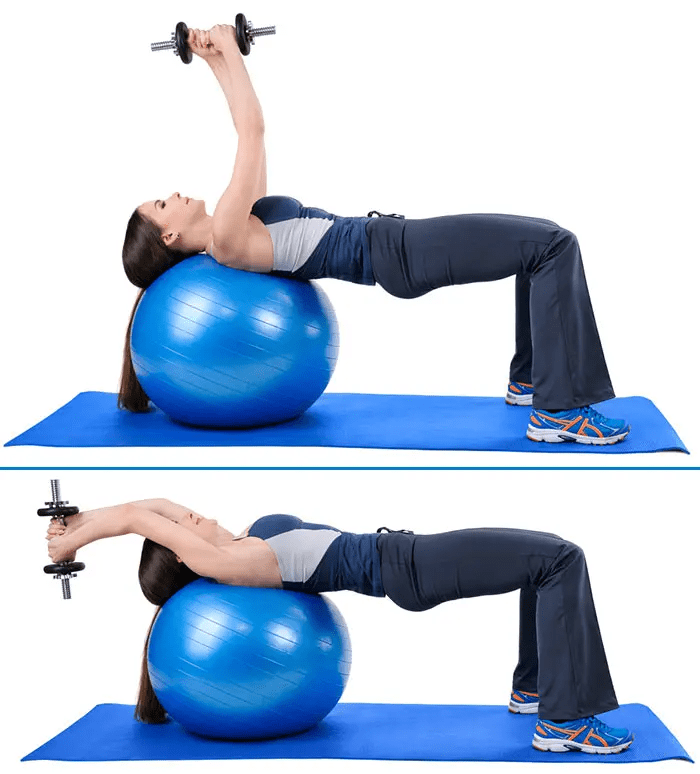 Dumbbell Pullover - woman in her blue sports wear and yoga mat