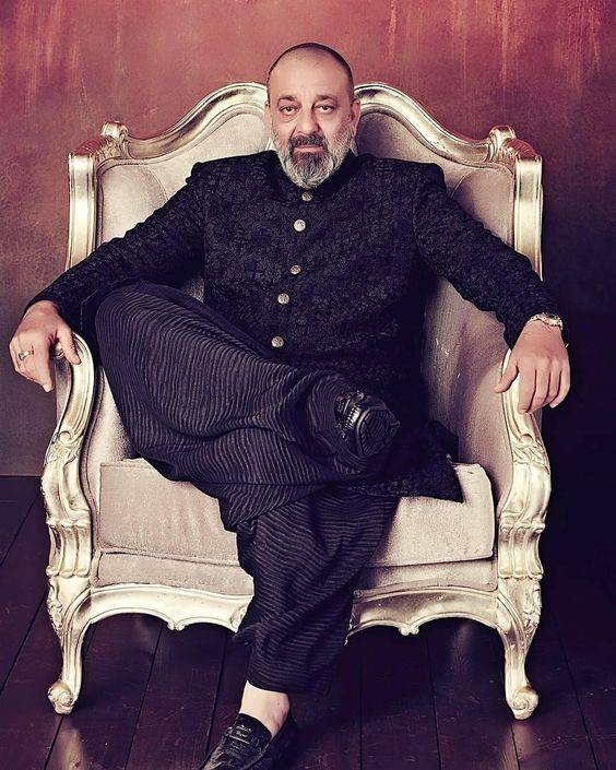 Sanjay Dutt sitting pose with shahi dress