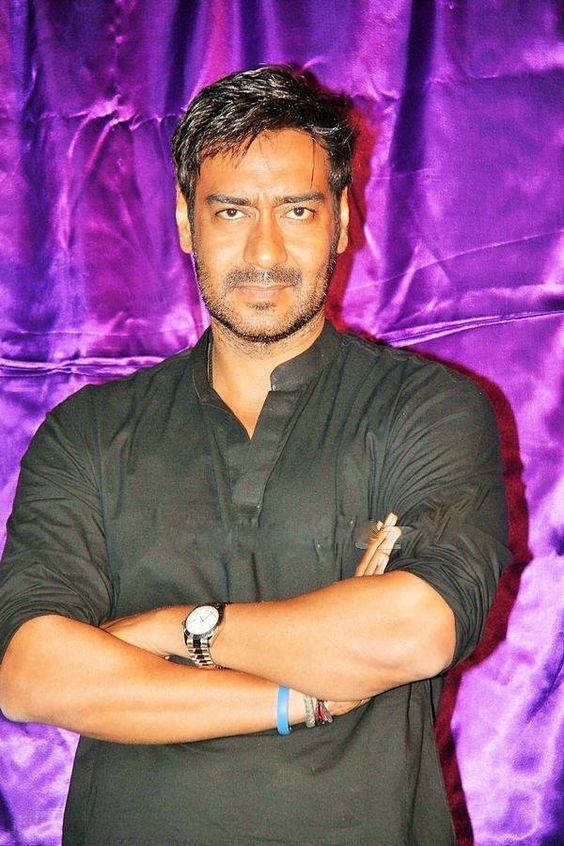 Ajay Devgn wearing black kurta in standing pose