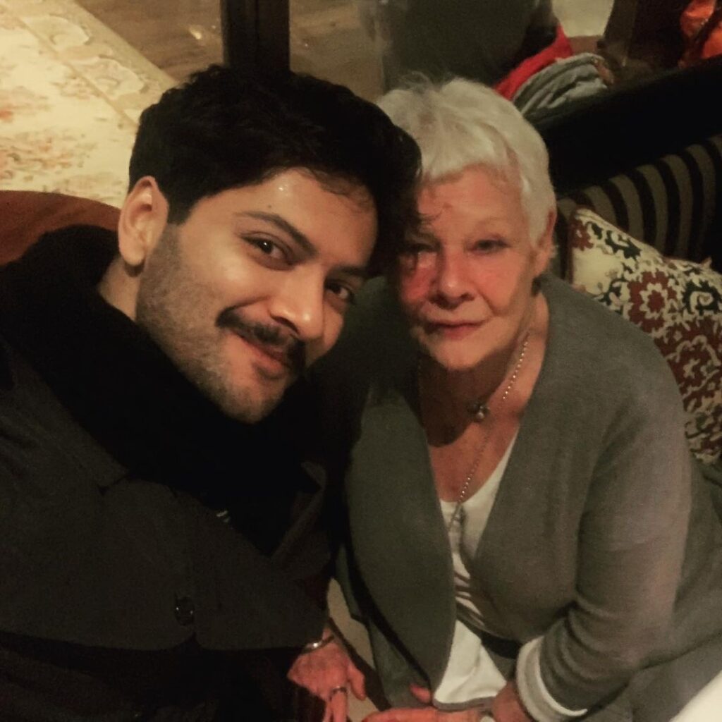 Ali Fazal pose with casual cropped hairstyle & sitting with his known