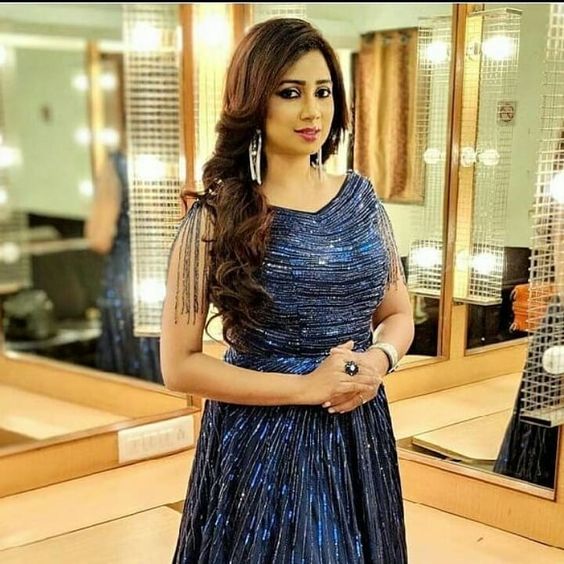 Shreya Ghosal wearing blue dress in standing pose