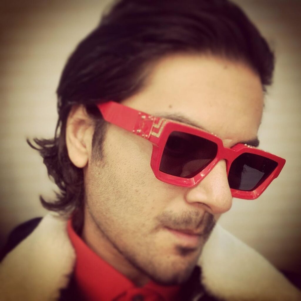 Ali Fazal pose with vintage slicked back hairstyle with dashing shades