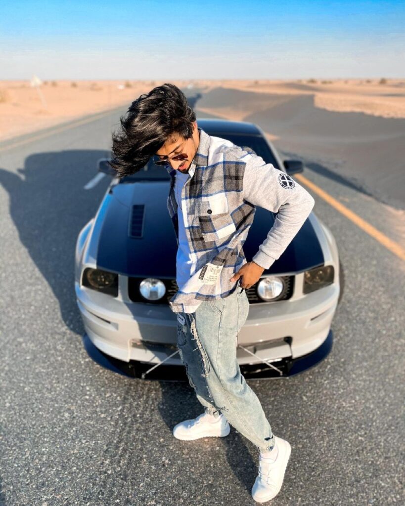 Wavy ruffled hairstyle  standing in front of car