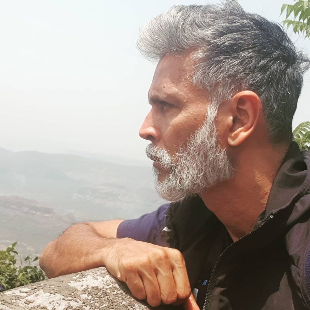 Milind Soman slight messy grey hairstyle