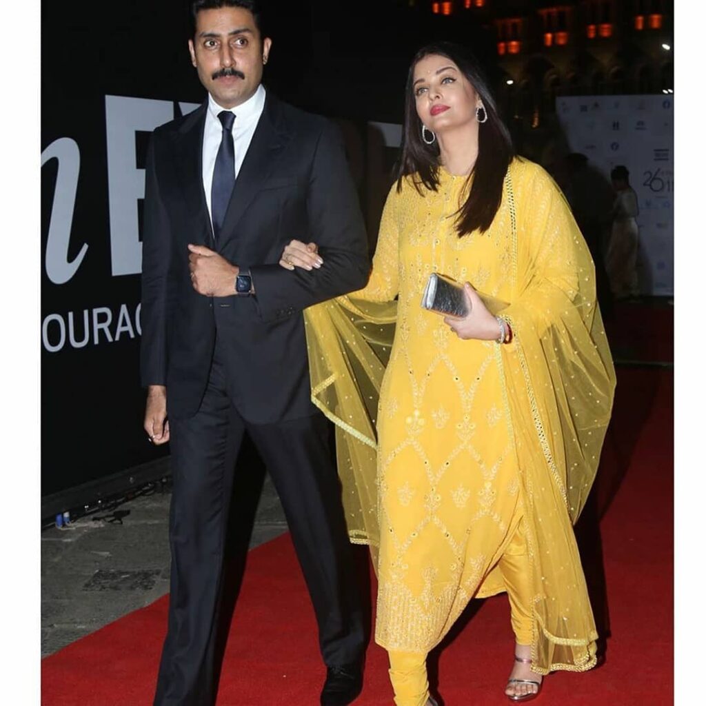 Abhishek Bachchan with Aishwarya Rai holding hands and walking - celebrity couple India 