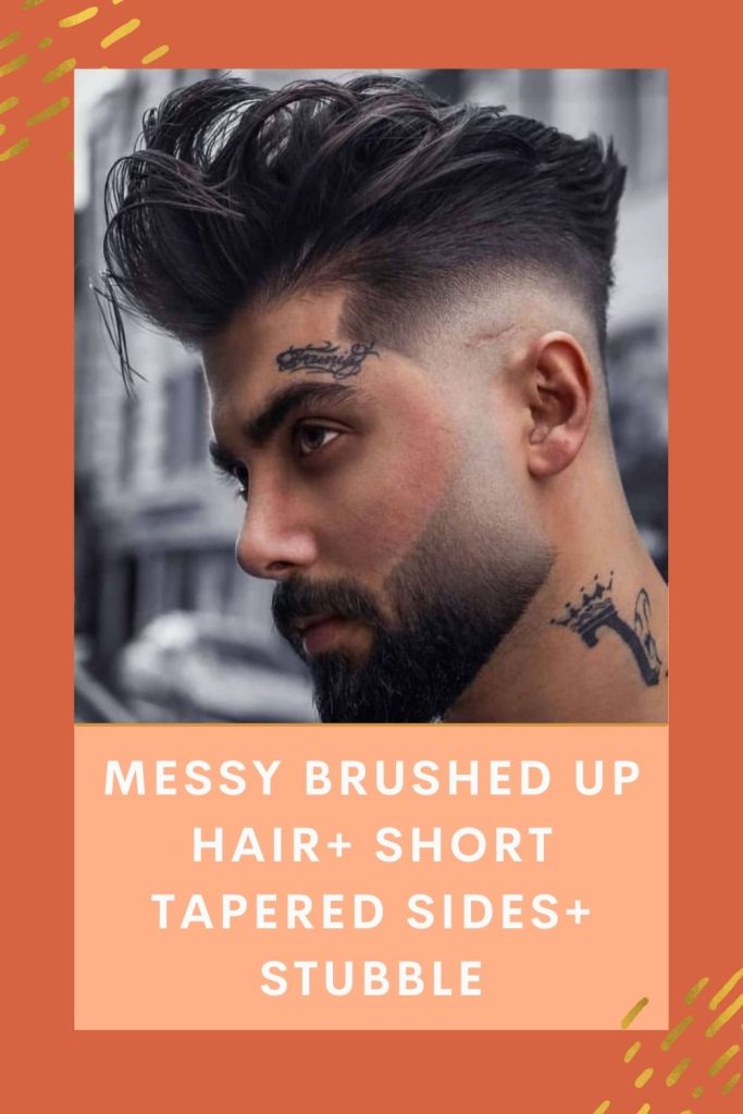 A tattoo guy is giving a side rough look and showing off his Messy brushed up hair+ Short tapered Sides+ Stubble - Beard Styles for Older Man