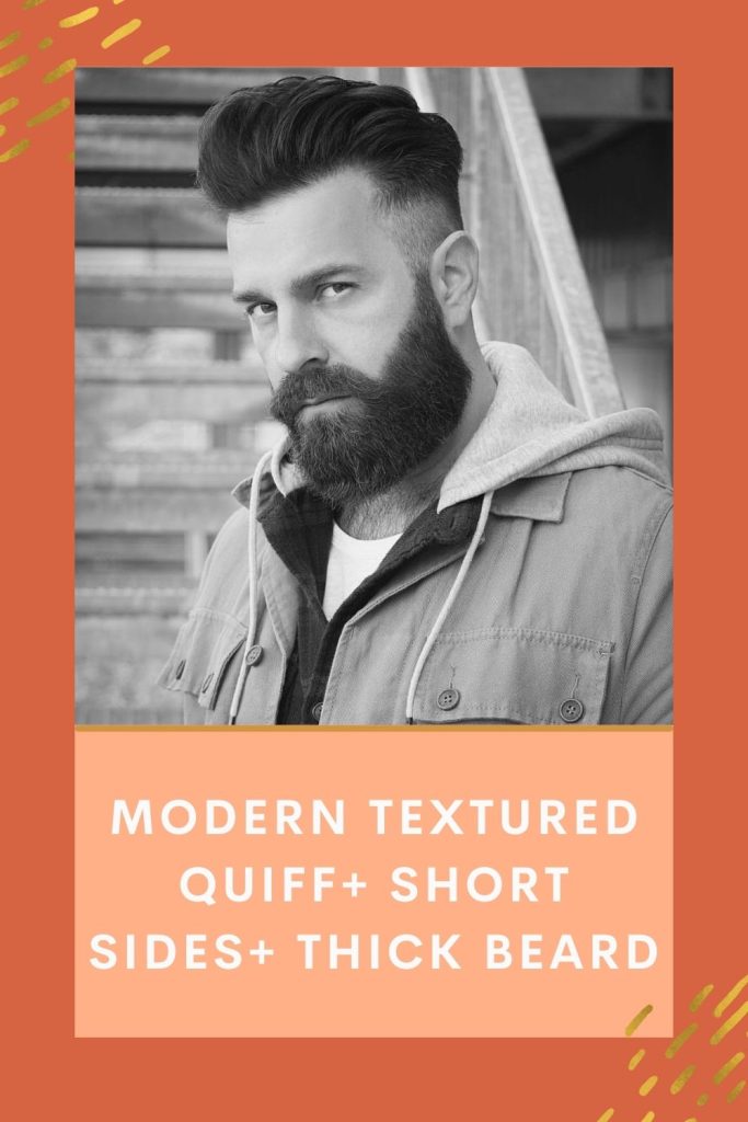 Guy is posing in a tough look and showing off his Modern textured quiff+ Short sides+ Thick beard - beard grooming