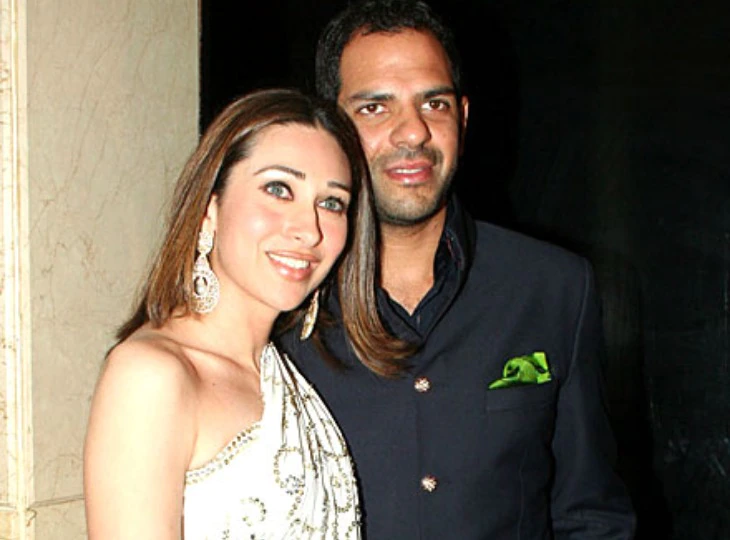 Karisma Kapoor in white dress and Sunjay Kapur in black suit posing for camera - most expensive divorce 2021