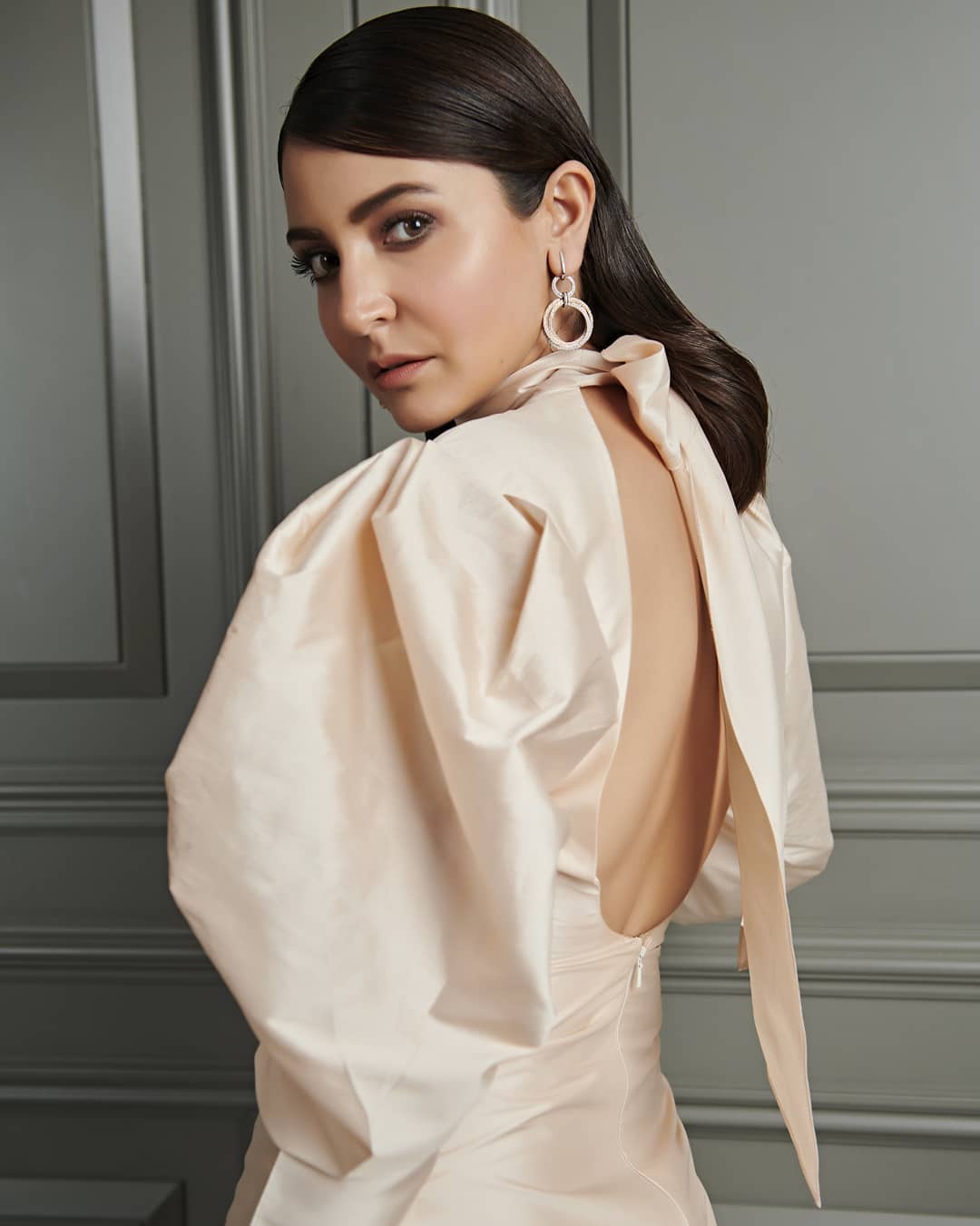 In off white deep neck dress anushka is giving the side pose - Anushka Sharma Hairstyles