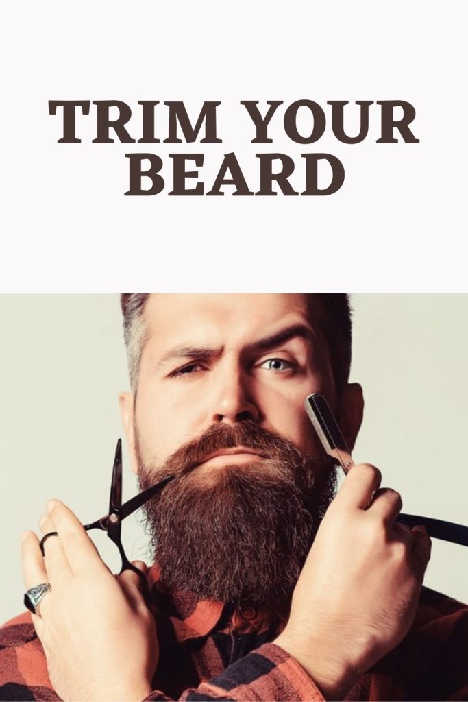 A man is showing razor and scissors  - How to Maintain Beard length 