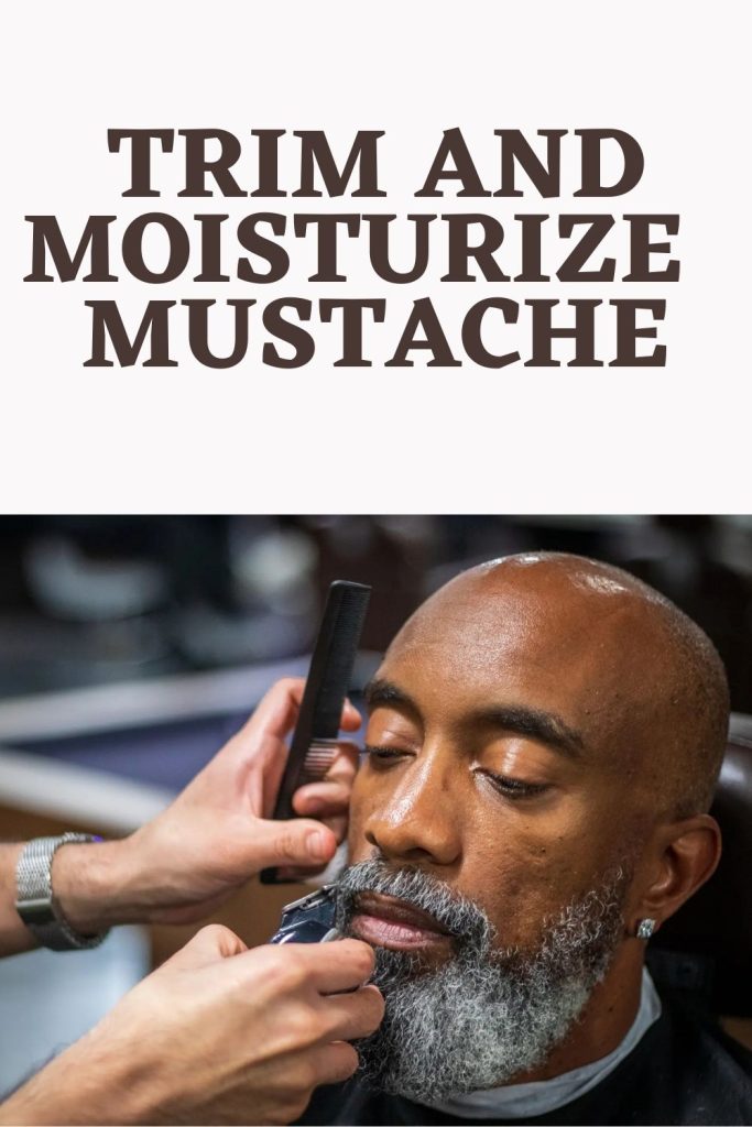 A bald man is trimming his mustache - beard care routine
