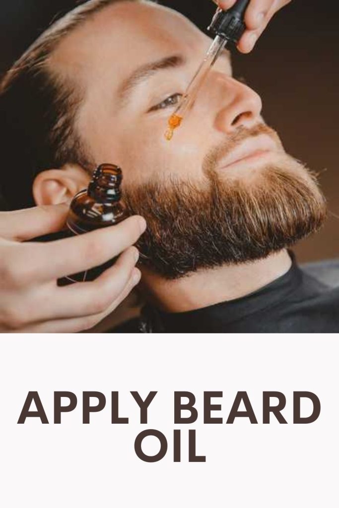 Barber is applying beard oil to a dark brown bearded gentleman - beard quiz questions