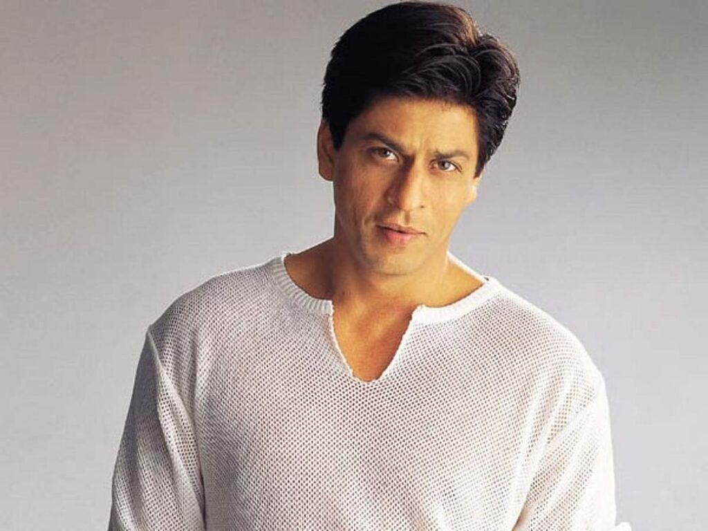 Shahrukh khan in white full sleeves t-shirt showing off his The Almost Mullet hairstyle - shahrukh khan hairstyles