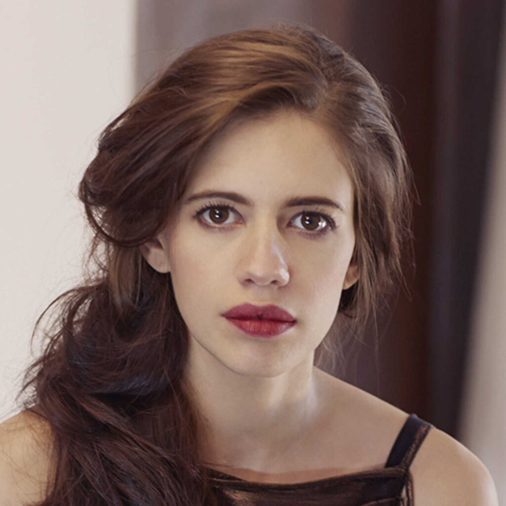Kalki Koechlin in black dress and brown lip color posing for camera - List of bollywood Actress Who became Pregnant before Marriage