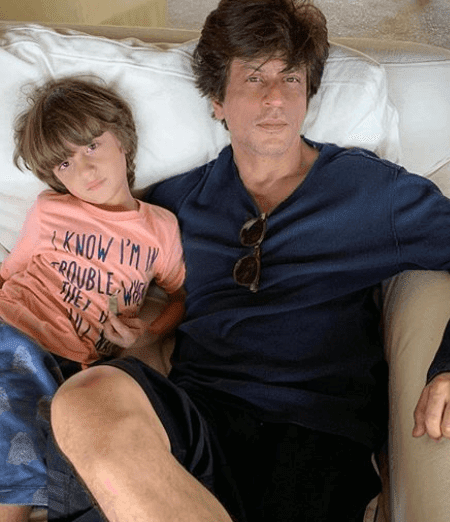 Shahrukh Khan with his son Abram lying a couch - shahrukh khan short haircut