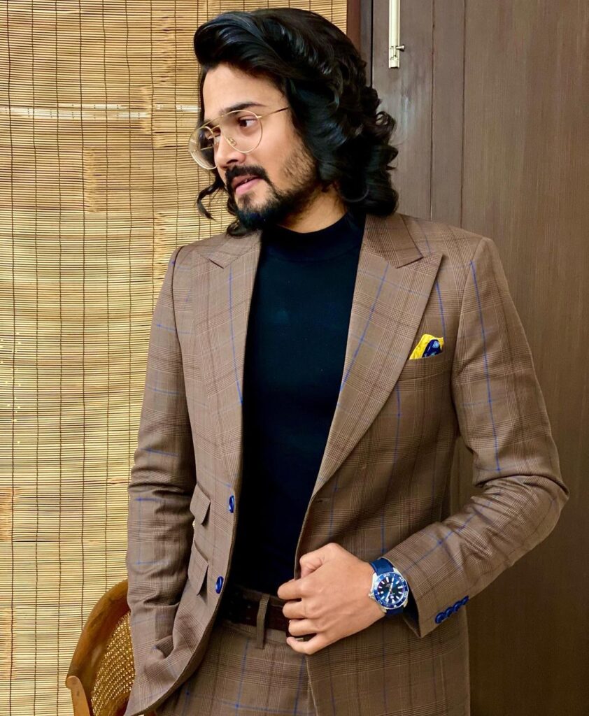 Bhuvan Bam in Grey Suit posing in his Medium and curly hairstyle - Bhuvan Bam Latest Hairstyle