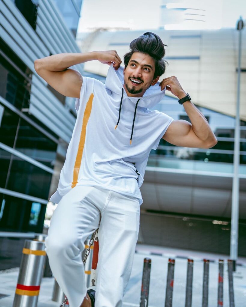 Faisal Shaikh in white t-shirt posing and showing his high Pompadour hairstyle - faisu latest hairstyle