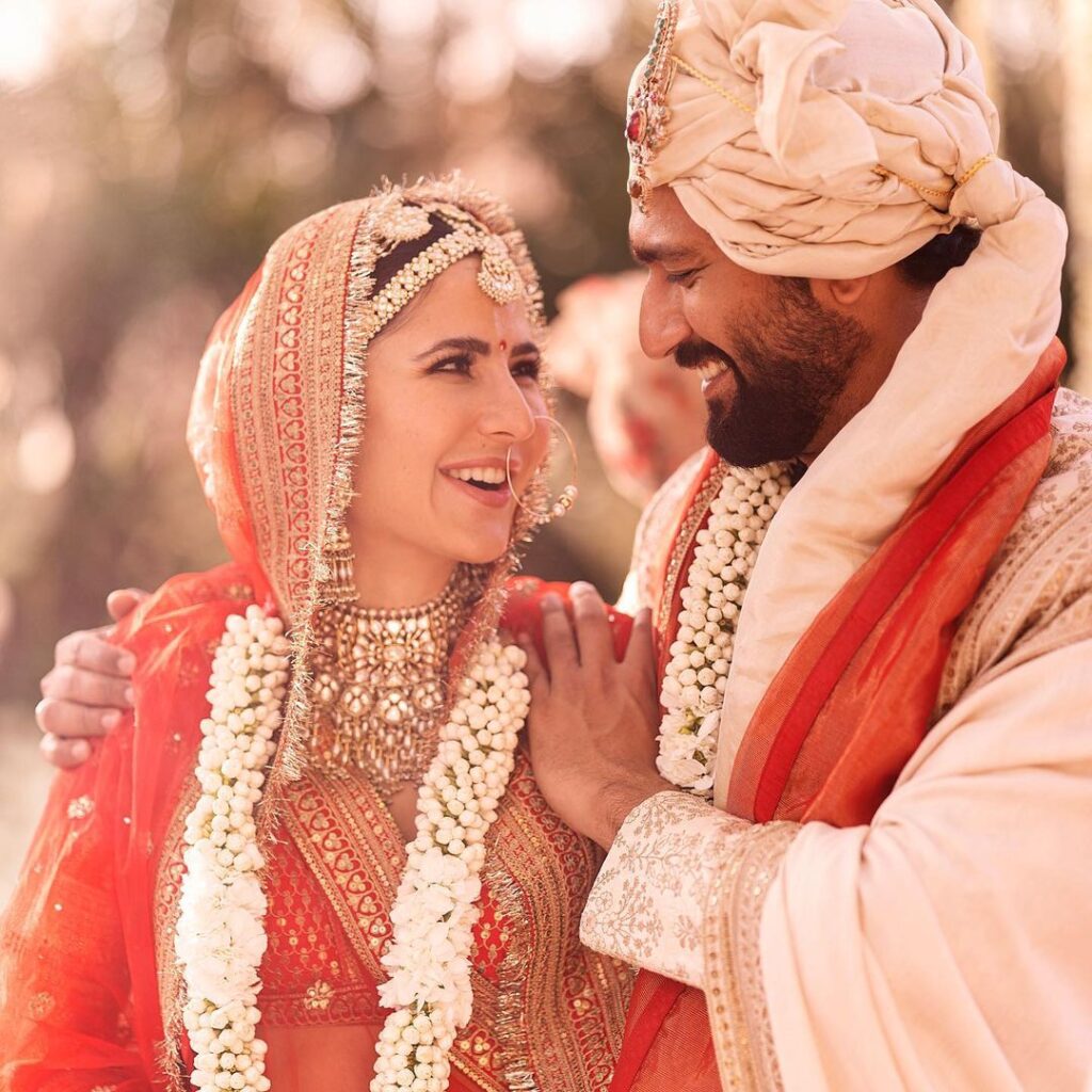 Katrina Kaif and Vicky Kaushal in their wedding outfit looking at each other -  cleberities who married older women