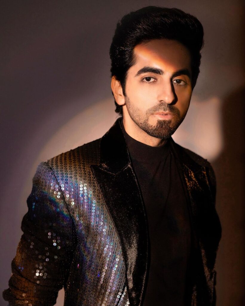 Ayushmann in dark brown shimmery jacket posing with his Pompadour hairstyle - Ayushmann new hairstyle