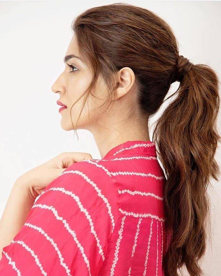 Kriti Sanaon in pink dress and high ponytail giving a  side pose for camera - hairstyles for tall girls