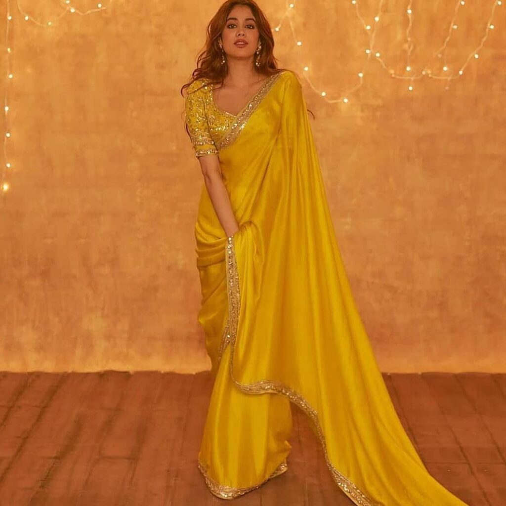 Janhavi Kapoor in yellow sari posing for camera - Indian actress with short haircut