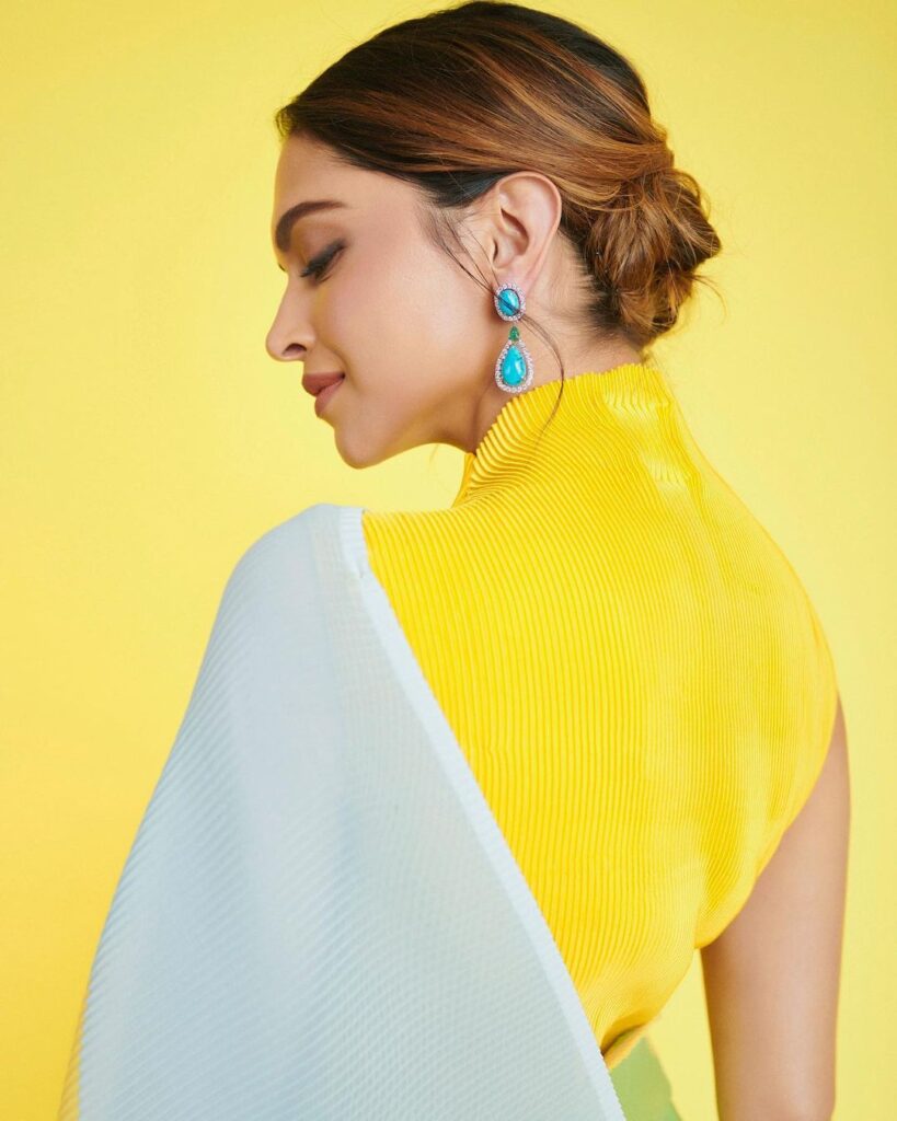 Deepika in yellow blouse and sky blue sari posing for camera - hairstyles for thin girls