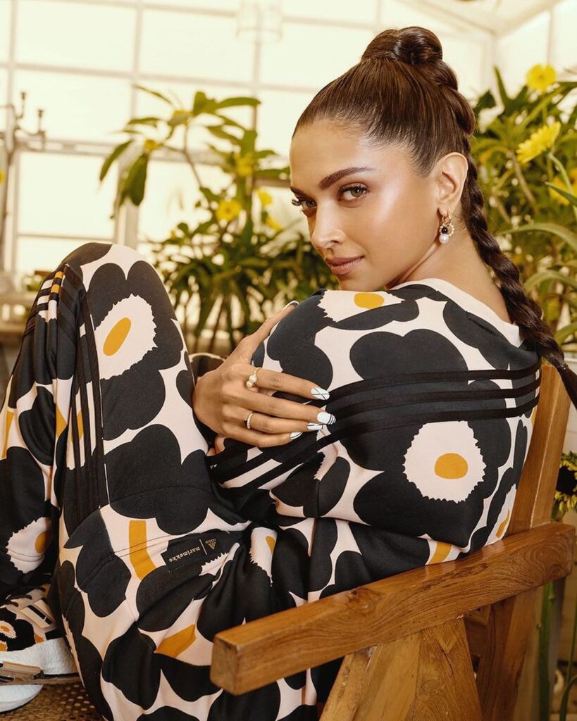 Deepika padukone in multicolor printed outfit with high braided ponytail posing for camera - hairstyles for thin girl