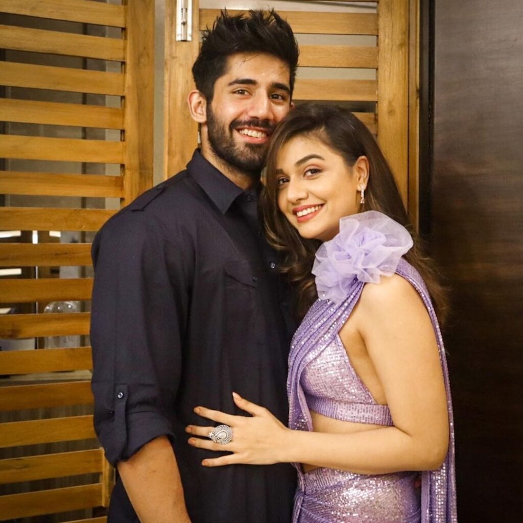 Divya Agarwal in purple shimmery dress and Varun Sood in black kurta posing for camera - indian celebrities live in relationship