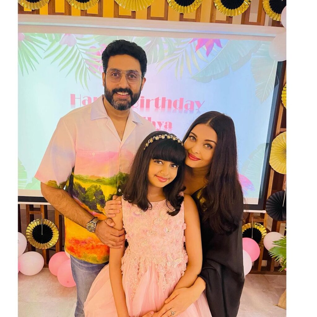 Aishwarya rai with husband Abhishek Bachchan and daughter in Center-parted sleek and straight hair - 40s hairstyles