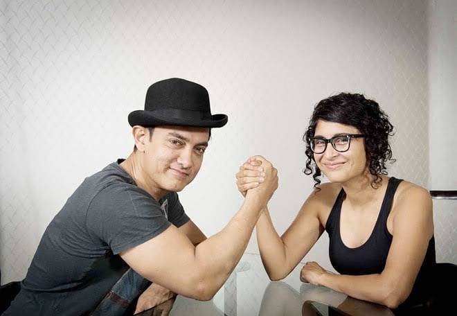 Aamir Khan and Kiran Rao in matching black outfit posing for camera - indian celebrities live in relationship