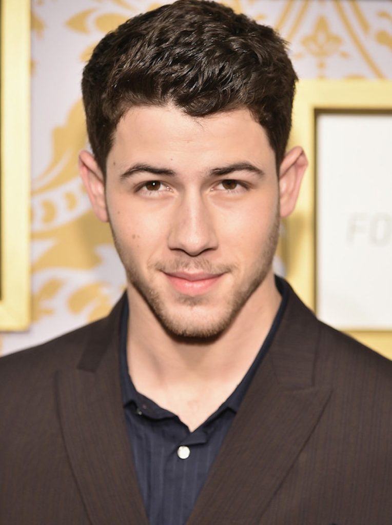 Nick Jonas in brown coat and blue shirt - professional women hairstyles