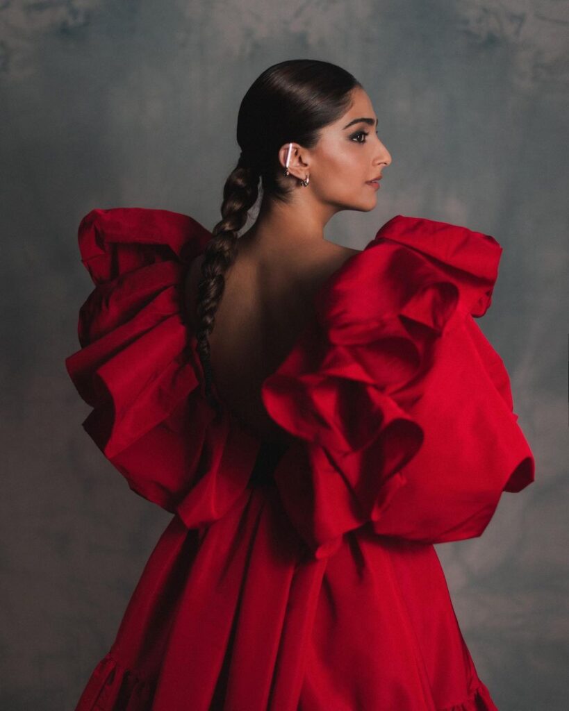 Sonam kapoor in red deep neck dress and Tight low braid - short hair