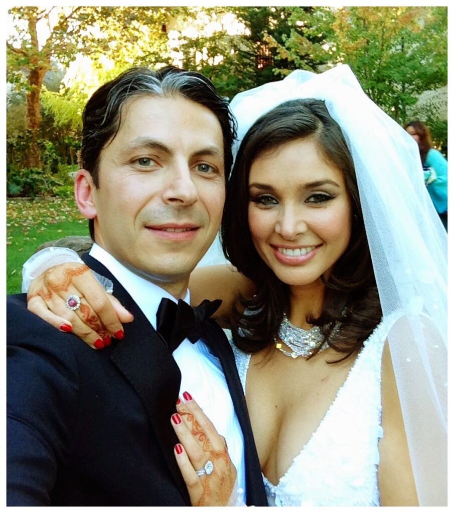 Lisa Ray and her husband in their wedding dress posing for a selfie - celebrities who got married after 40