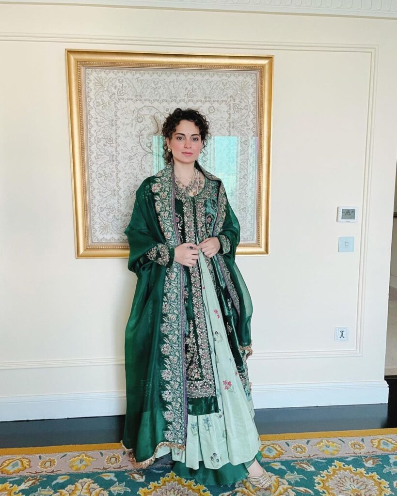 Kangana Ranaut in green suit posing for camera and showing her Low ponytail with curly bangs hairstyle - Kangana Ranaut haircut name