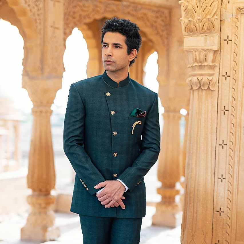 Sahil Shroff posing for camera in green suit - models in India 2022
