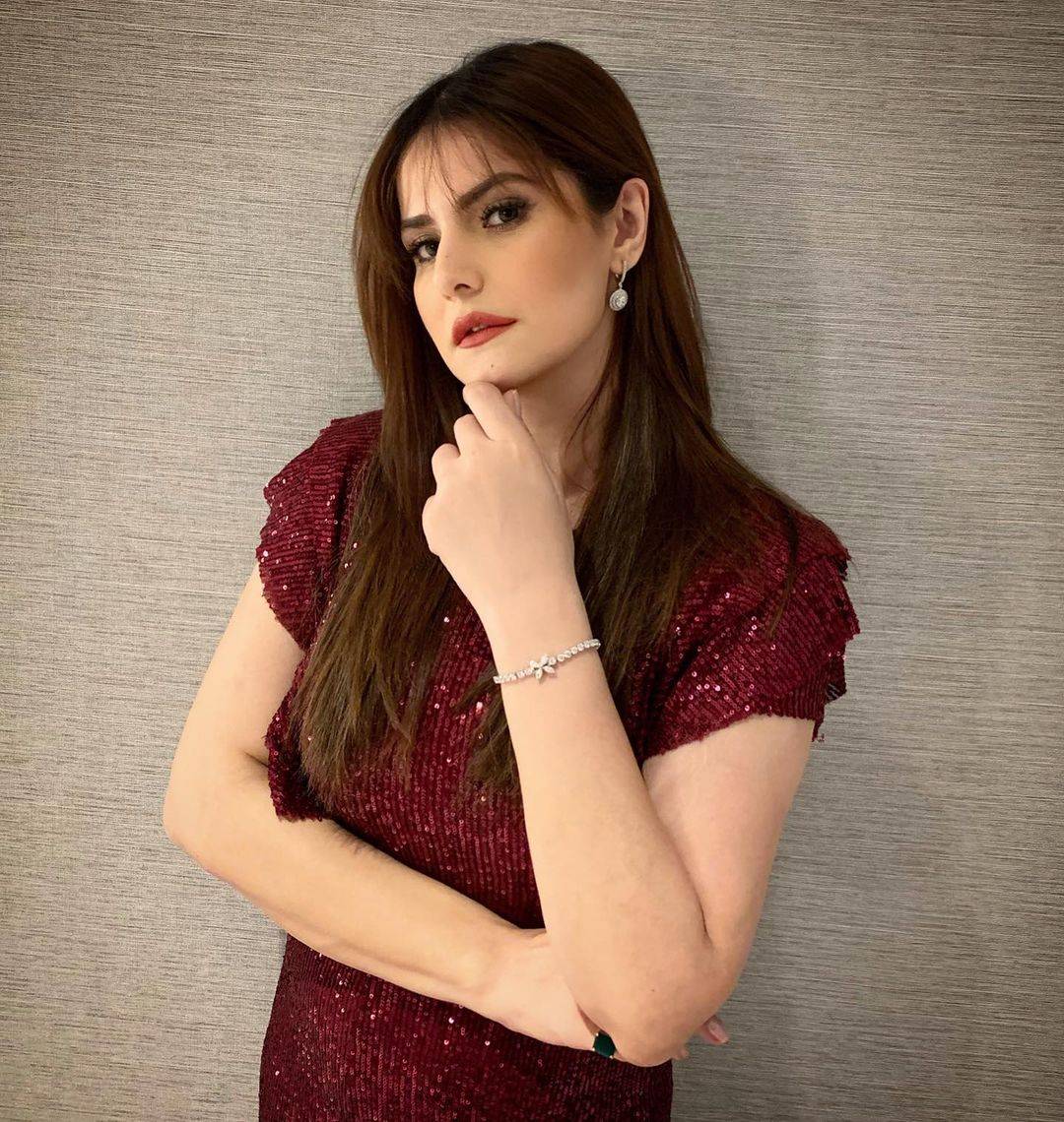 Zareen Khan in red shimmery dress and blunt bangs hairstyle - hairstyles for working women