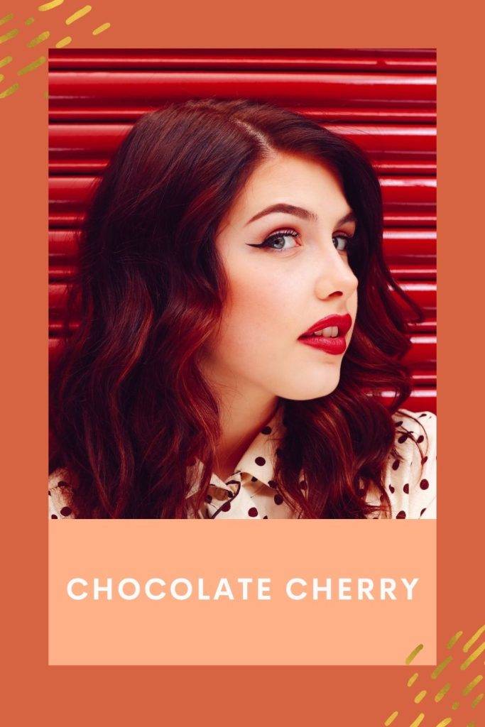 A girl in polka dotted dress is showing her Chocolate Cherry hair color - hair color trends