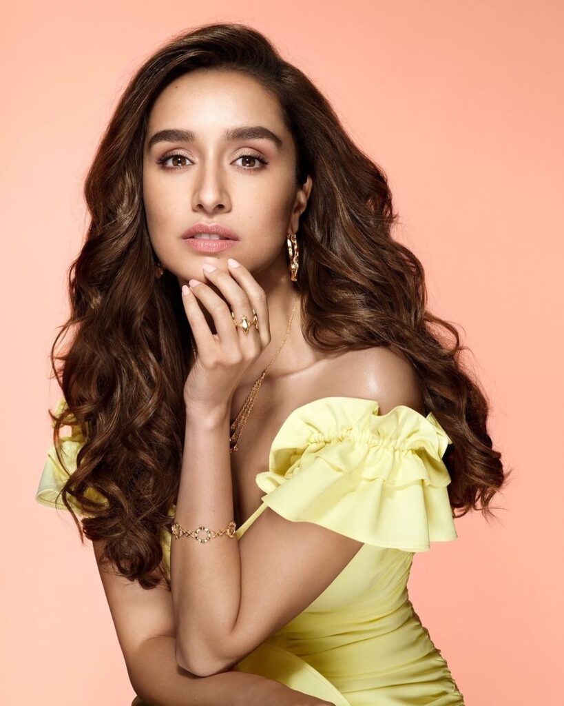 Shraddha Kapoor in light yellow color off shoulder dress posing for camera with loose curls - long hair