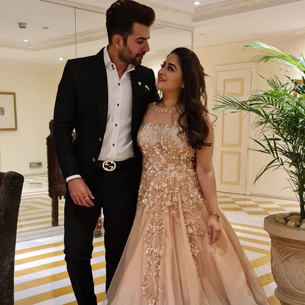 Jay Bhanushali in black suit with white shirt and Mahhi Vij in peach gown posing for camera - south indian celebrities couple age gap