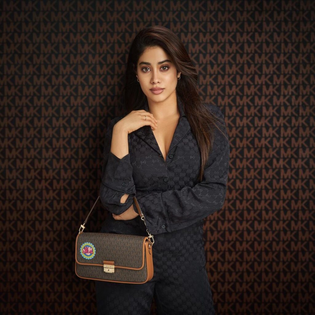 Janhavi Kapoor in holding a bag with black self design black coat dress - short hair